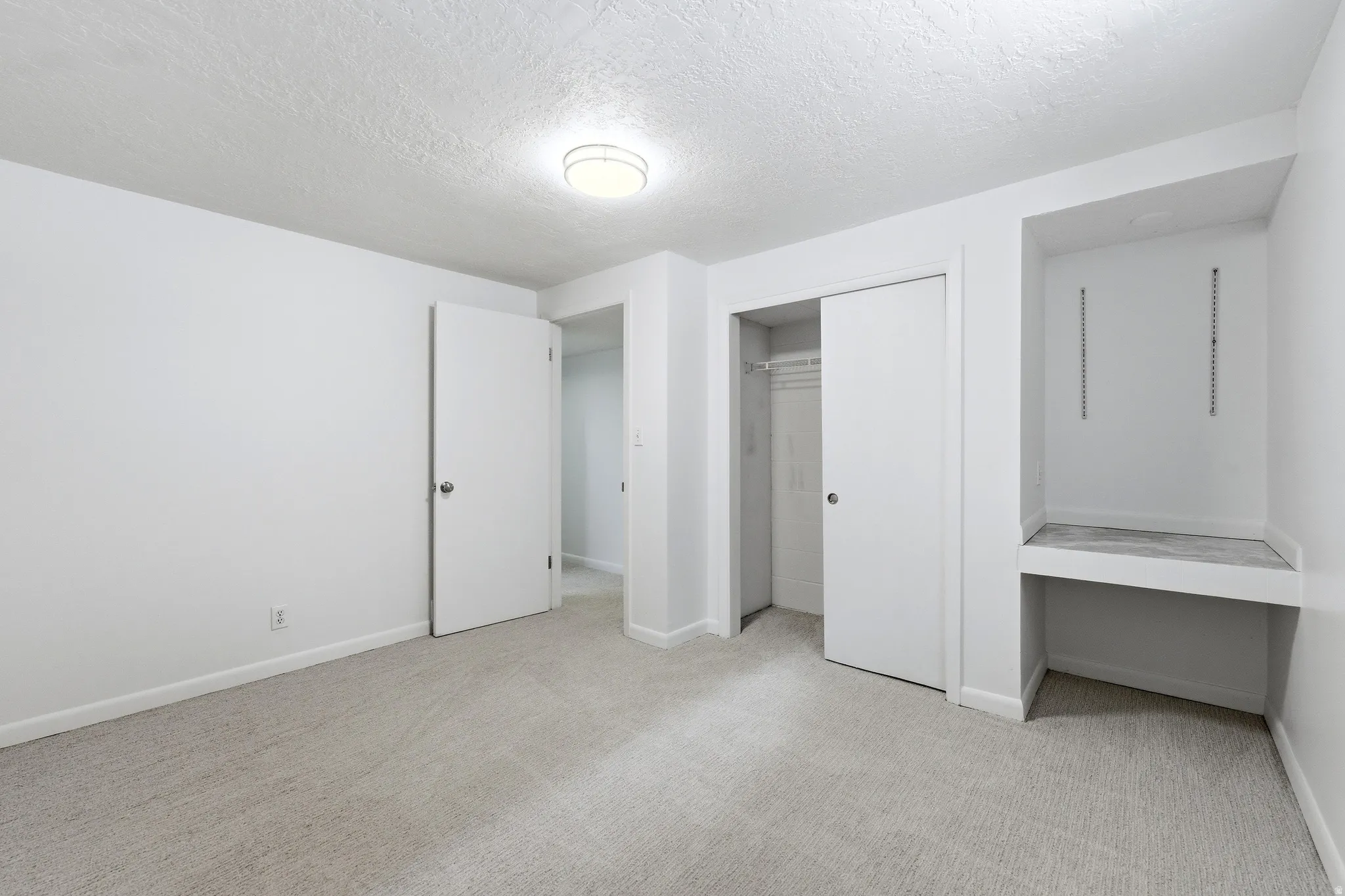 Neutral-toned carpeting paired with white walls