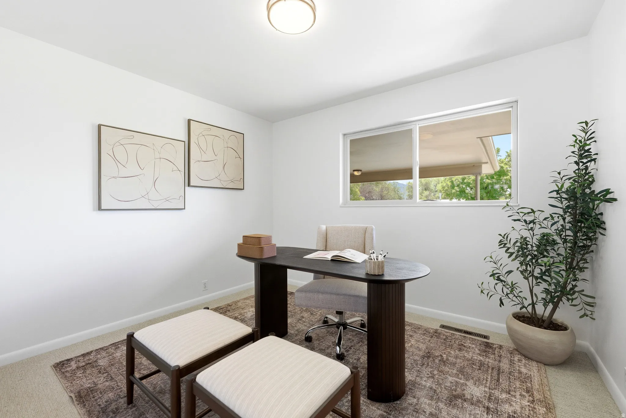 This room features a neutral color palette, a rectangular window, and carpet flooring