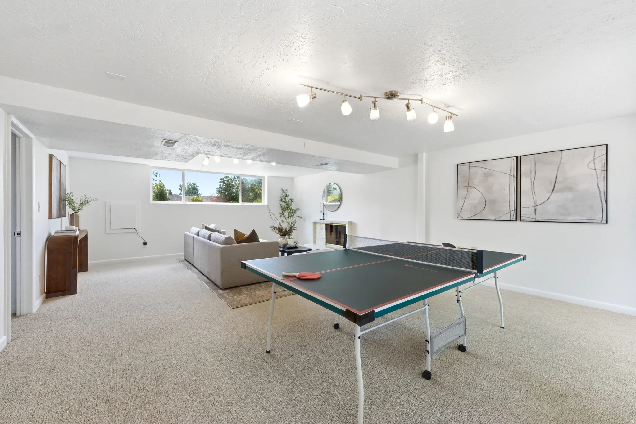 Spacious lower-level room featuring light-toned carpeting and recessed lighting