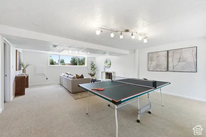 Spacious lower-level room featuring light-toned carpeting and recessed lighting
