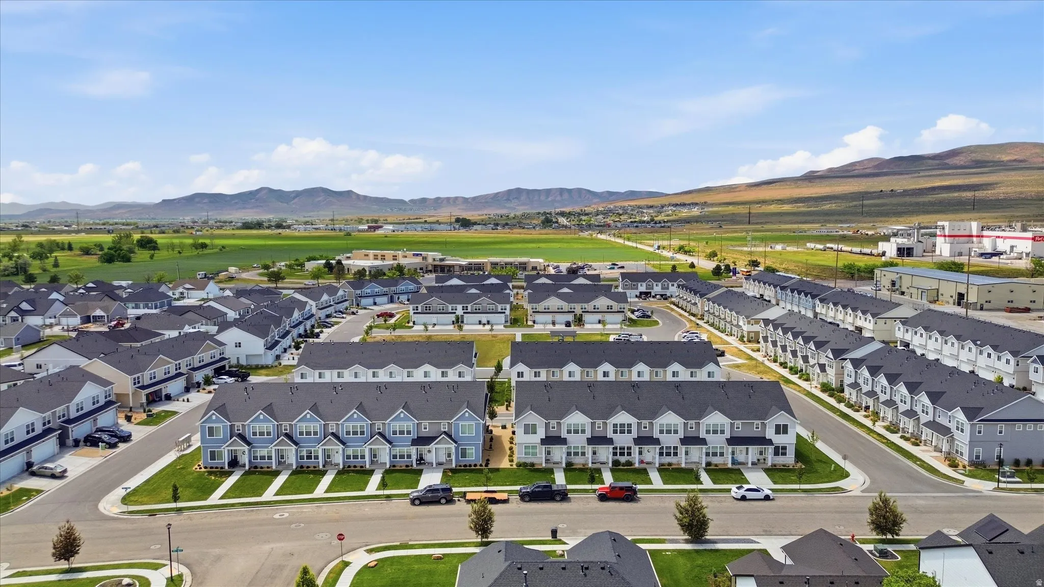 Aerial perspective showcasing a community of townhomes and single-family residences