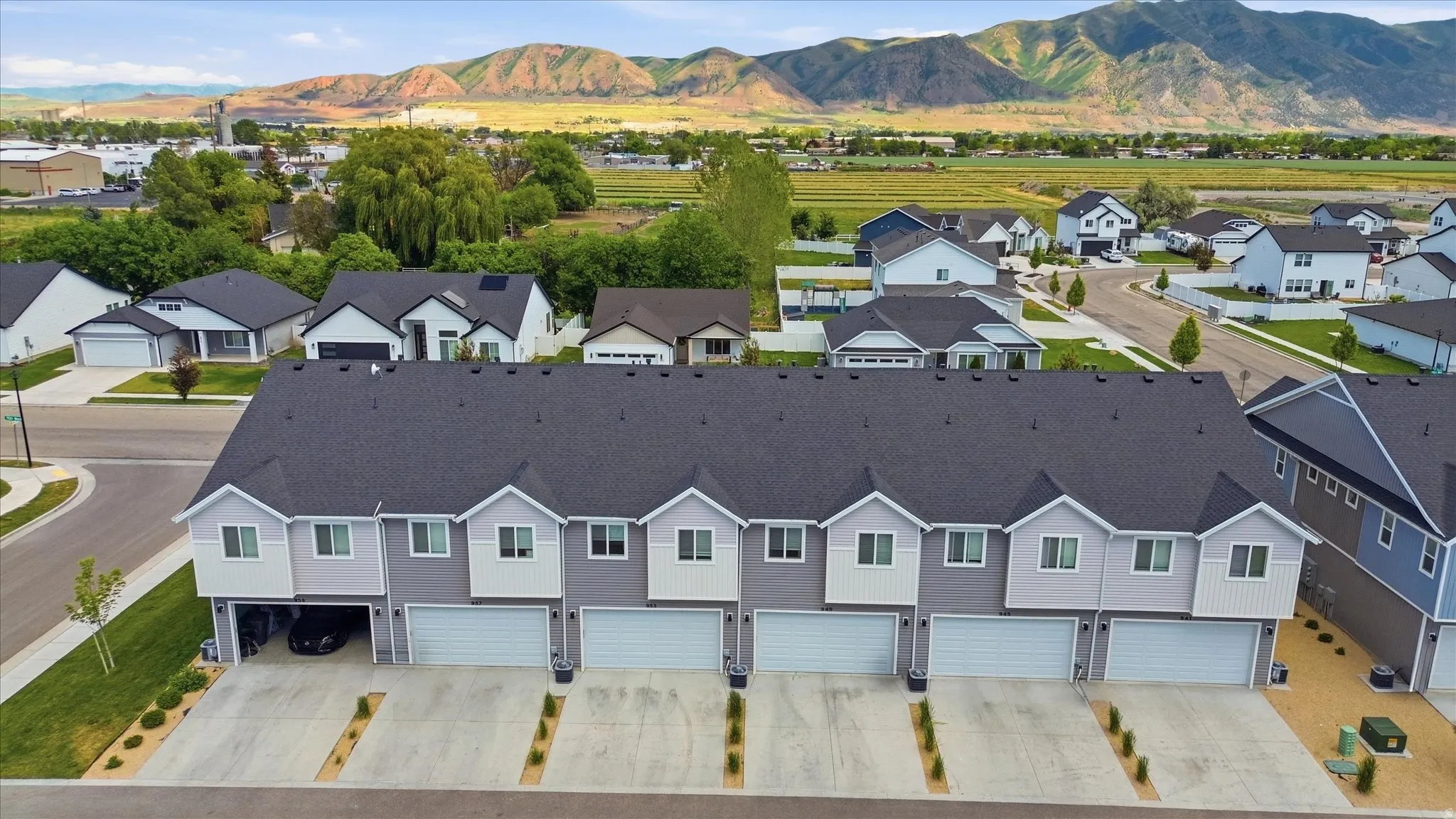 Modern multi-unit property featuring a dark gray roofline and light gray siding