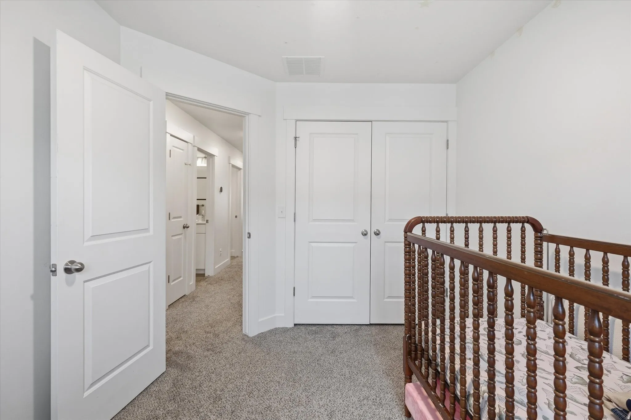 Bright room with light gray carpet and white walls