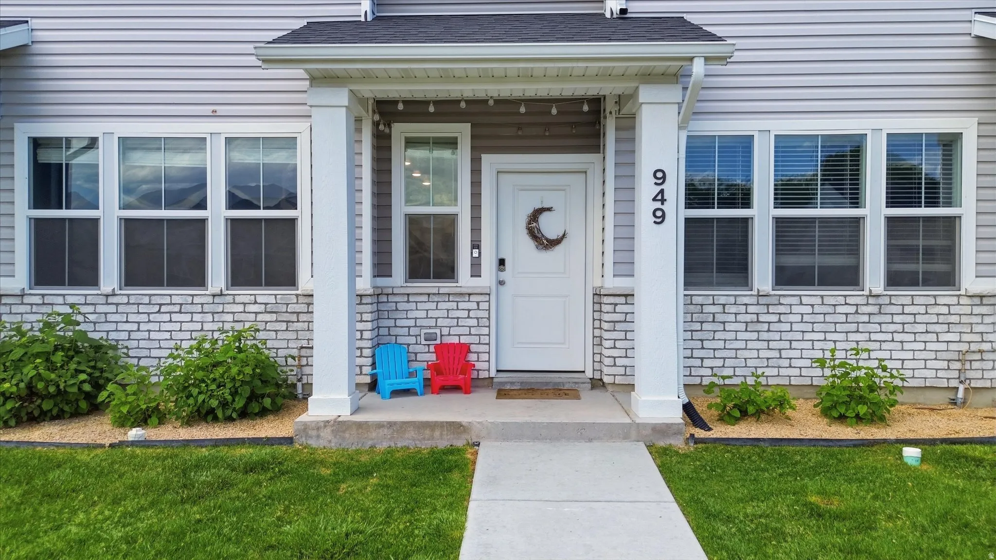 Light gray siding exterior with white brick detailing