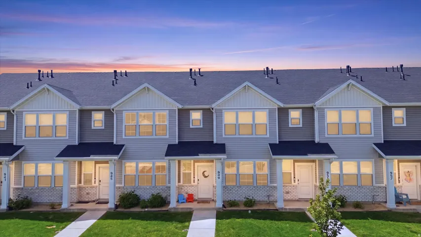 Contemporary townhome exteriors featuring light gray siding and white trim