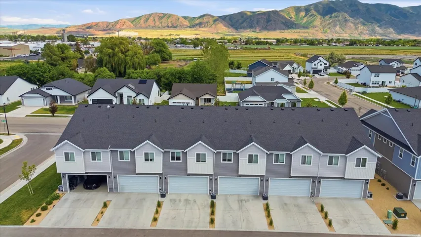 Modern multi-unit property featuring a dark gray roofline and light gray siding