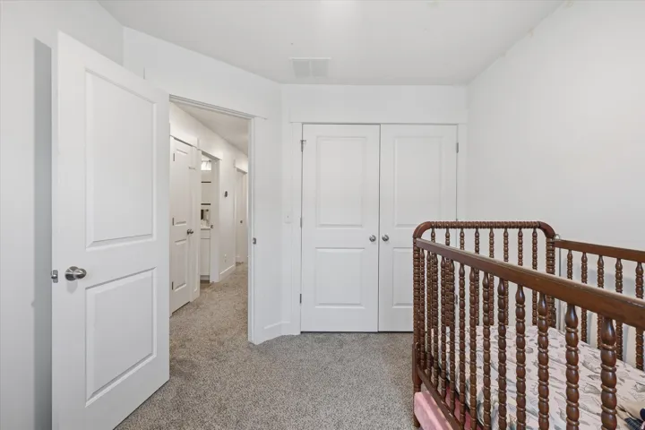Bright room with light gray carpet and white walls