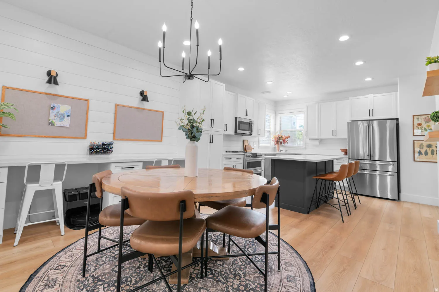 Open-concept kitchen and dining area featuring light wood-finish flooring