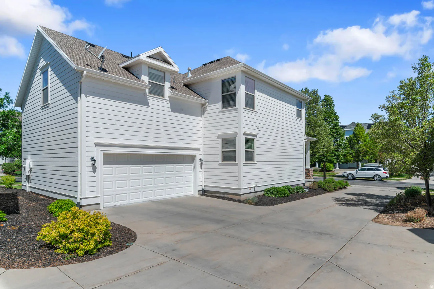 White horizontal siding exterior with a two-car garage