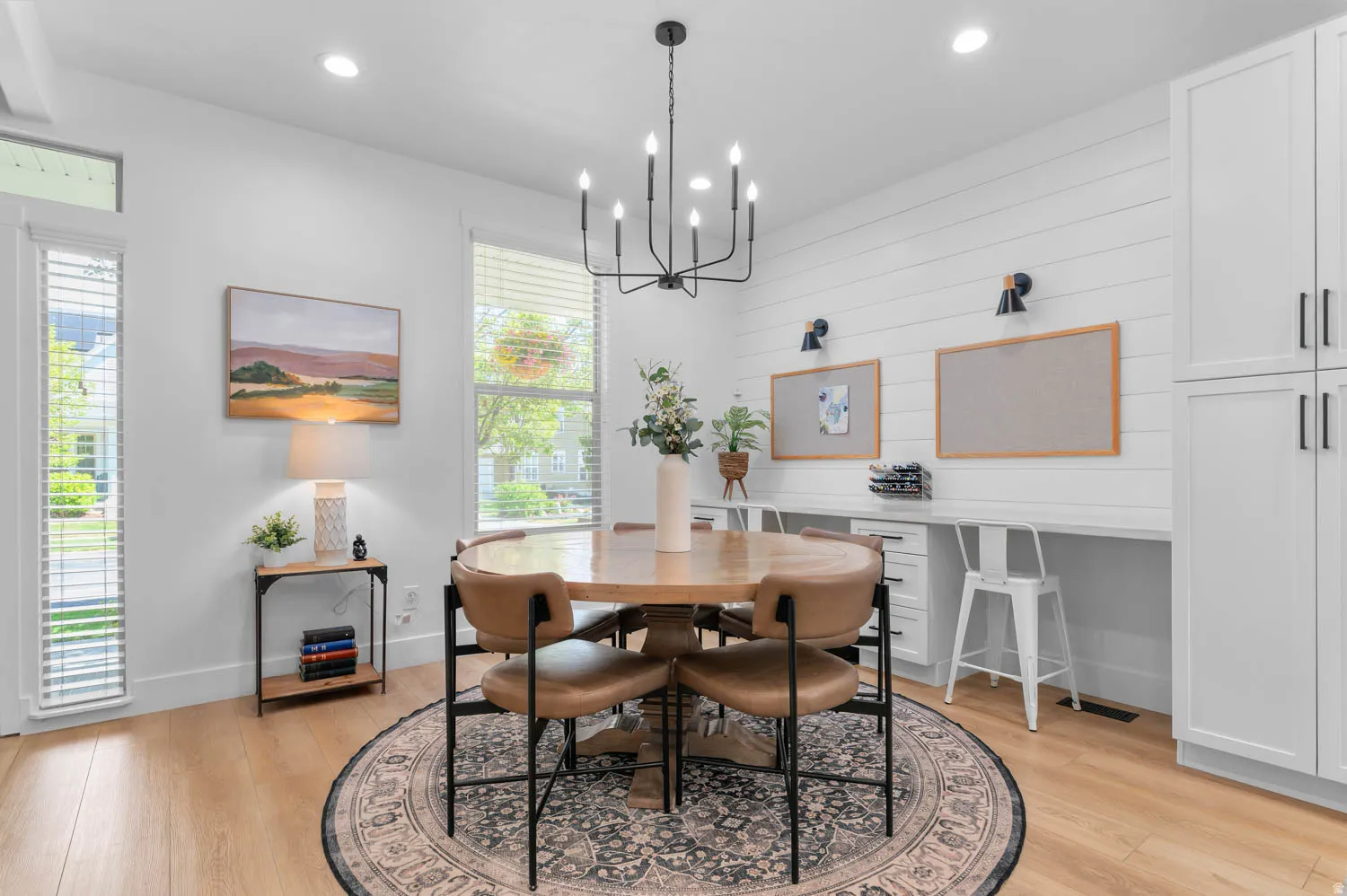 Bright dining area featuring wood-finish flooring and a central chandelier
