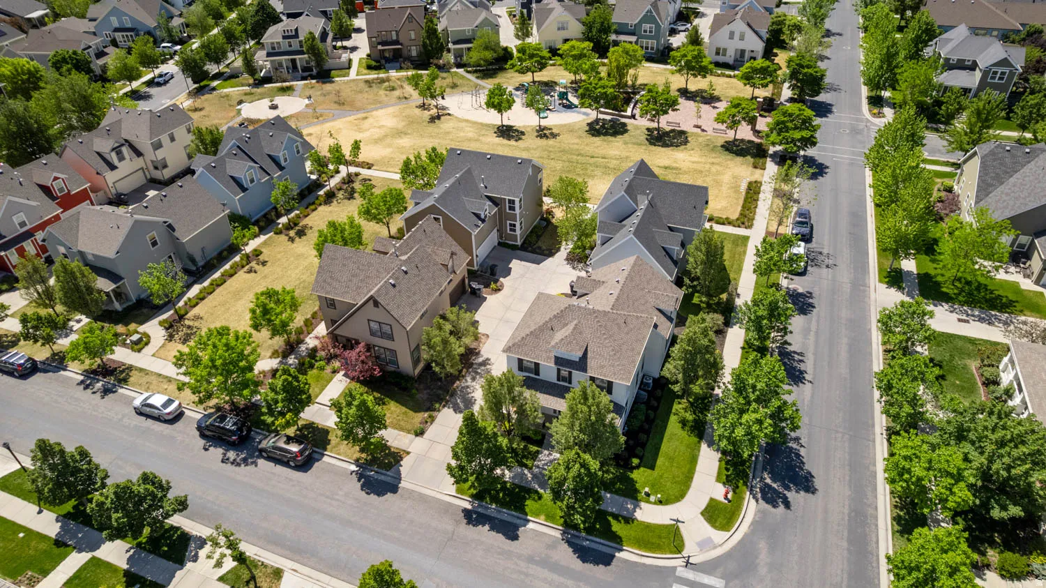 Neighborhood setting featuring a variety of architectural styles, mature street trees, and sidewalks