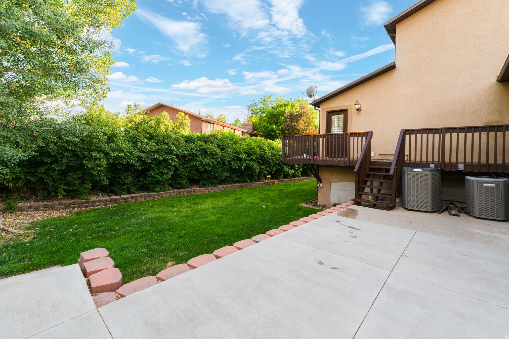 Expansive concrete patio with brick edging