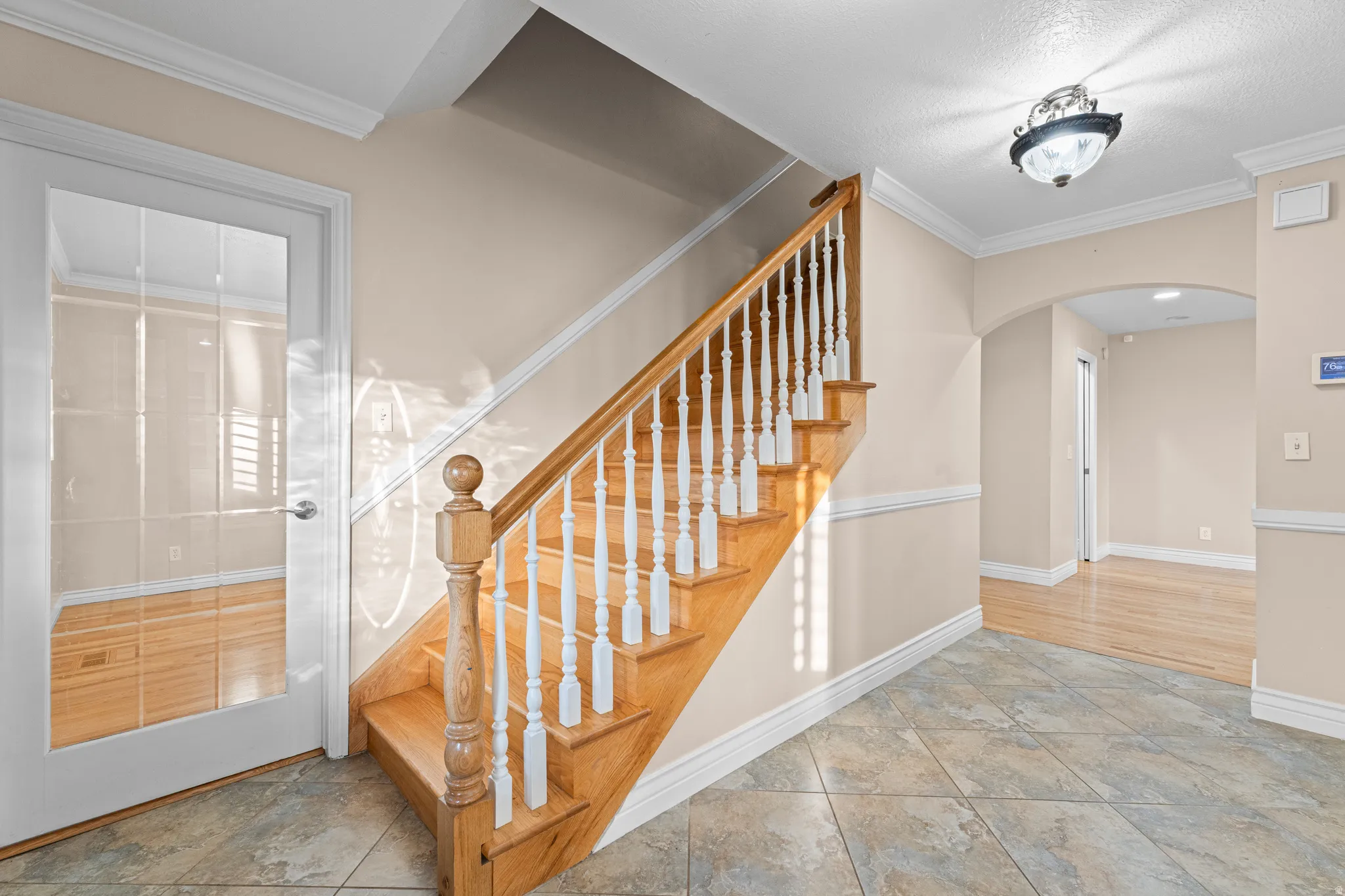 Staircase featuring wood steps and handrail with white balusters