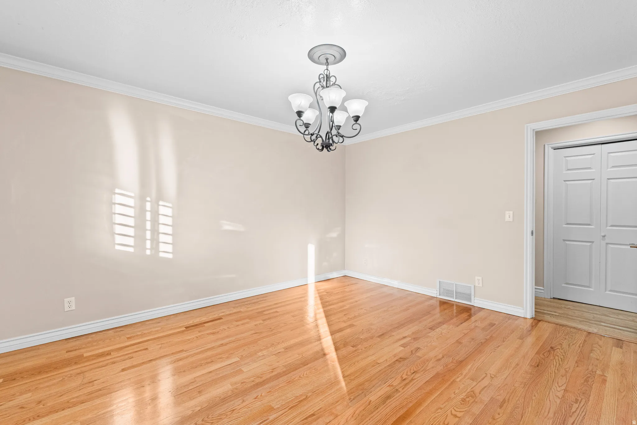 Hardwood flooring extends throughout this room, complemented by neutral wall tones