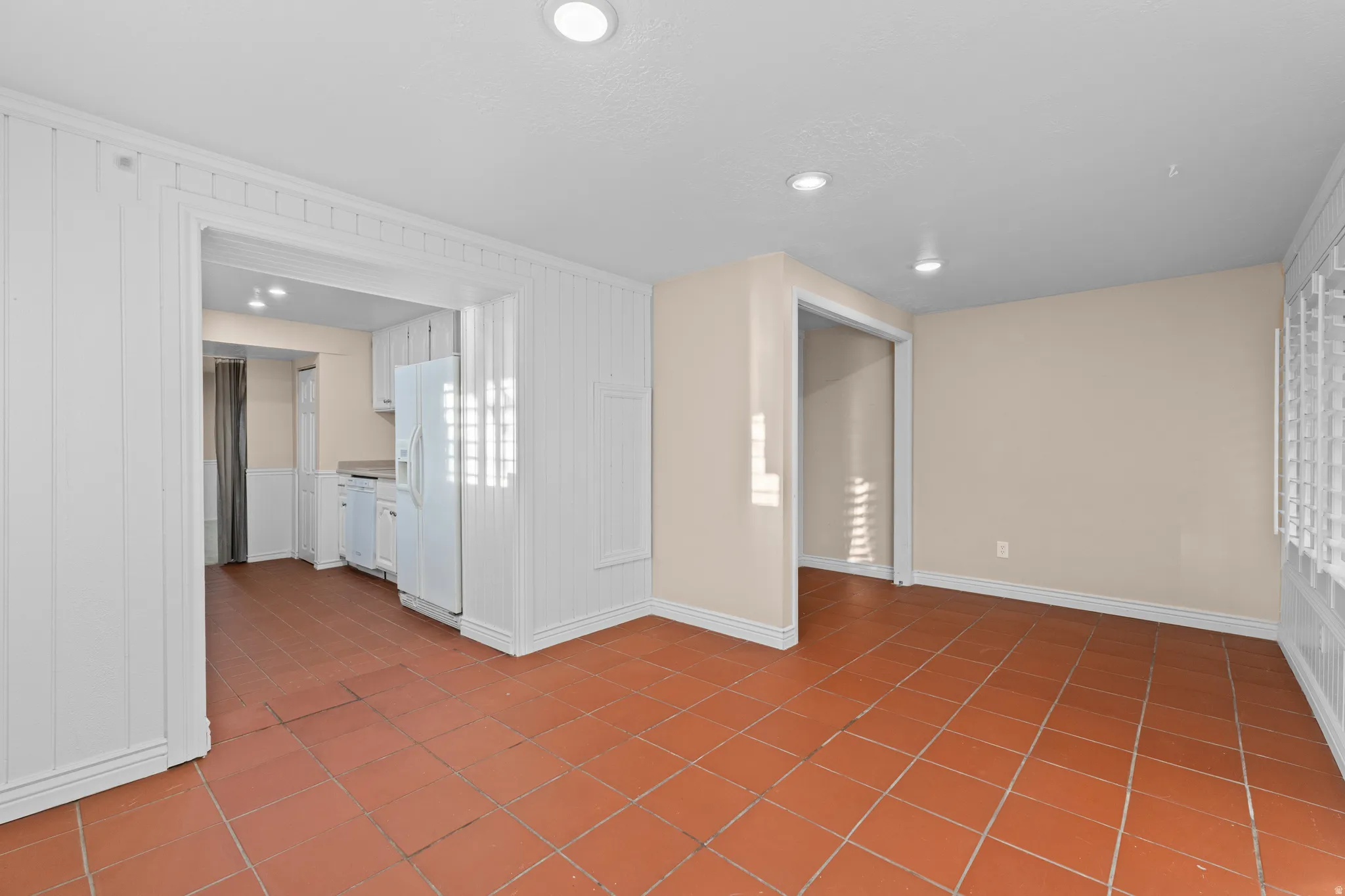 Expansive tile flooring extending into the kitchen