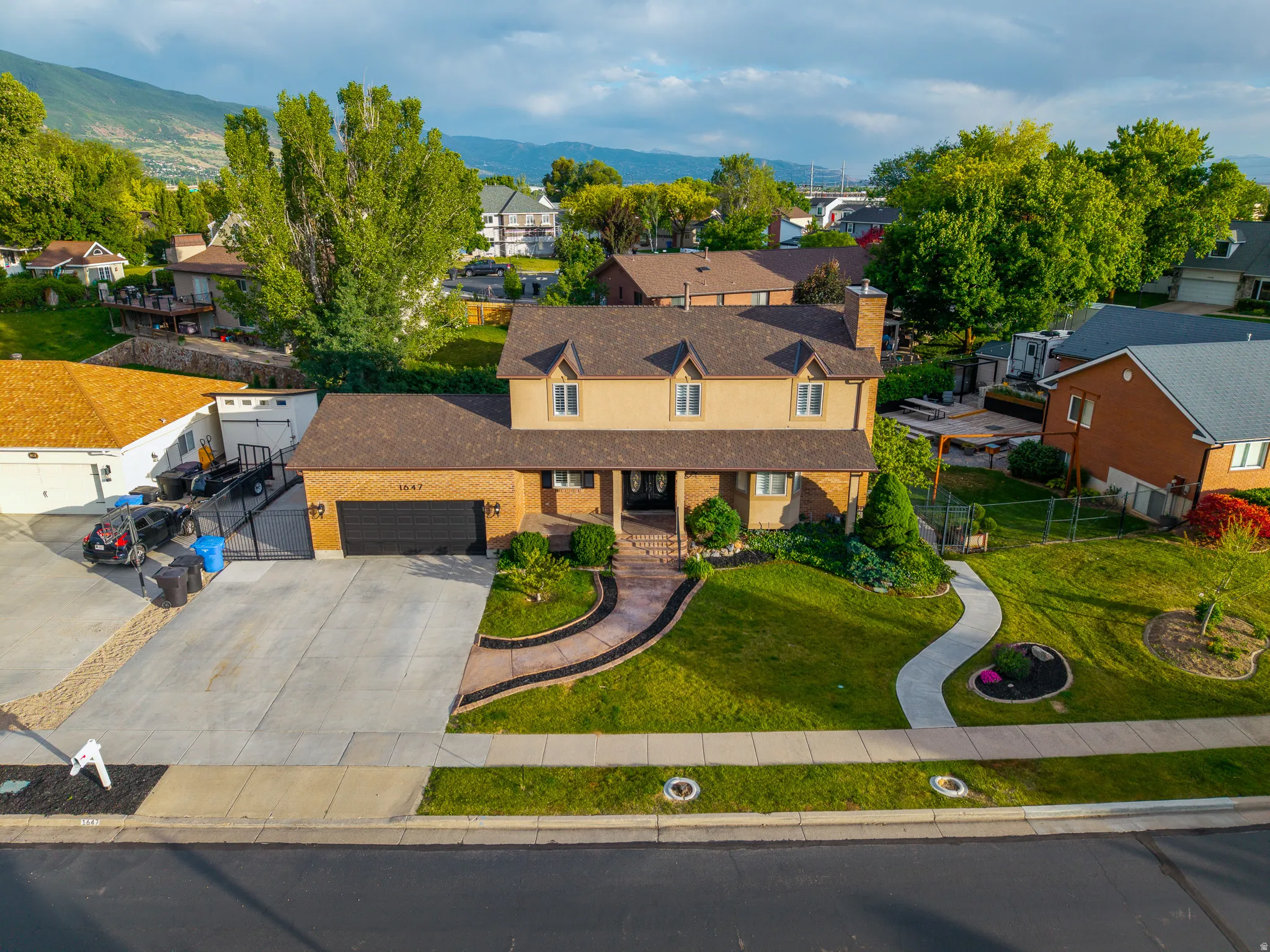 Two-story property featuring a brick and stucco exterior