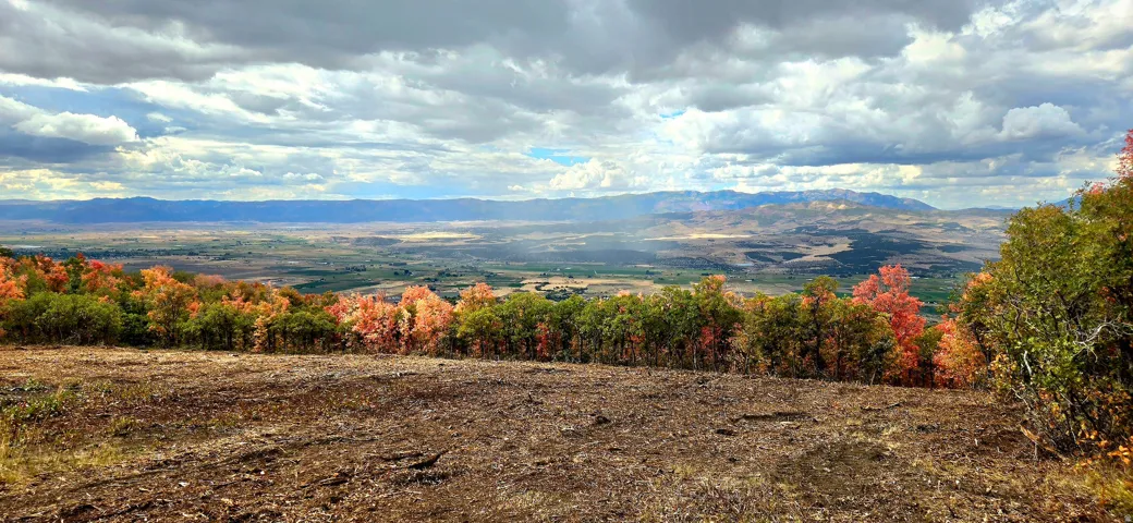 Elevated terrain featuring expansive land and distant mountain ranges