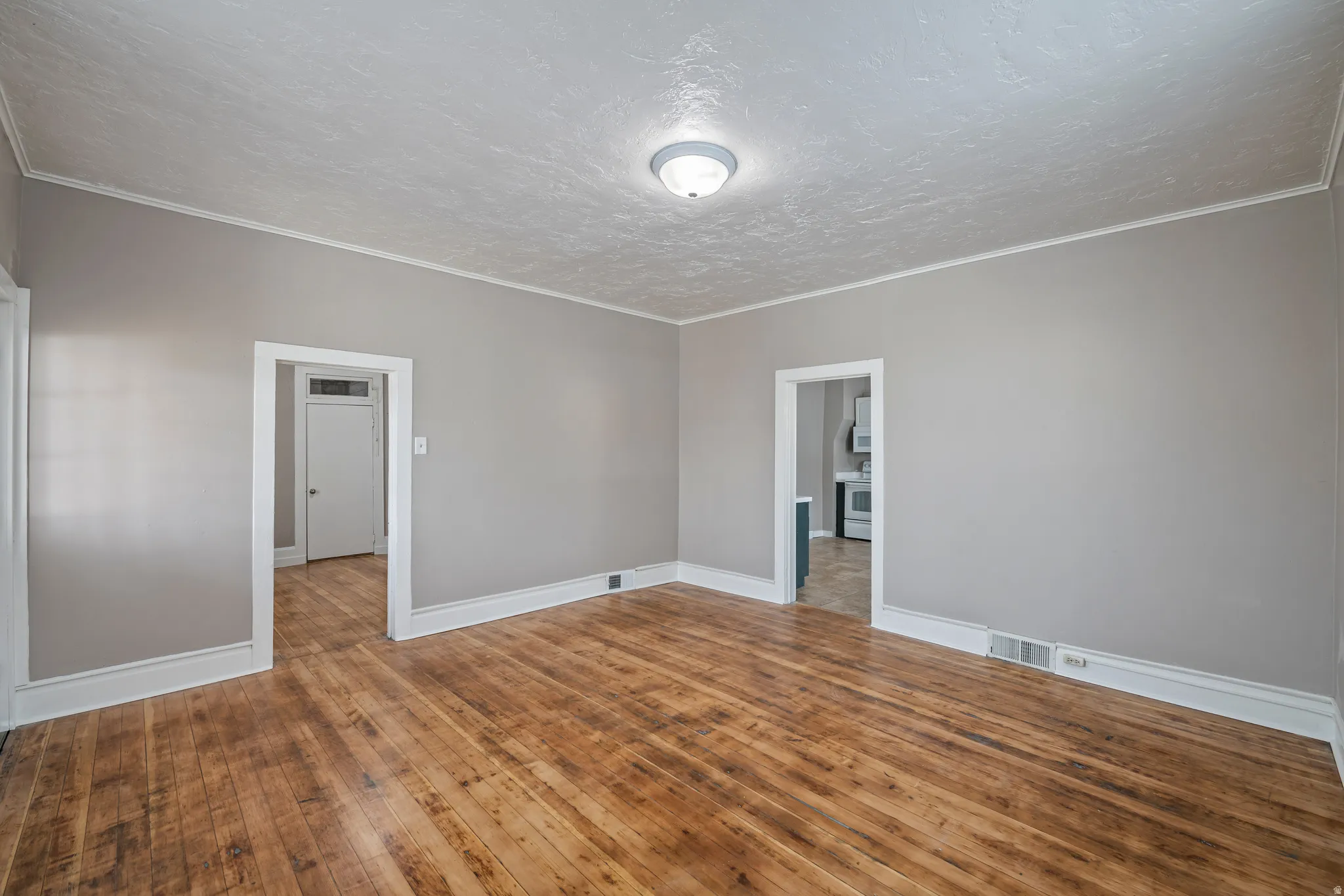 Wood-finish flooring with white baseboards