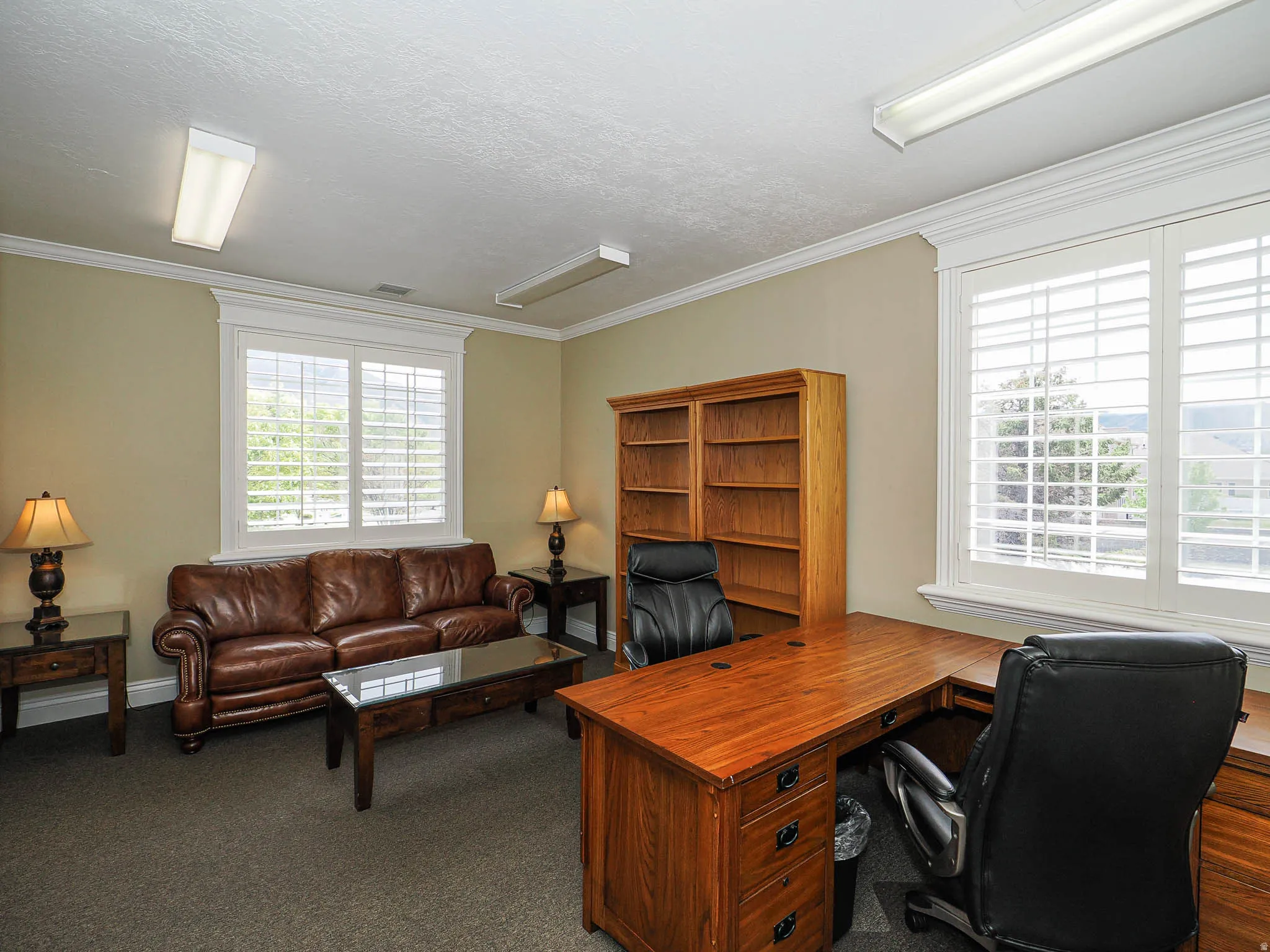 Office area with dark carpet and crown molding