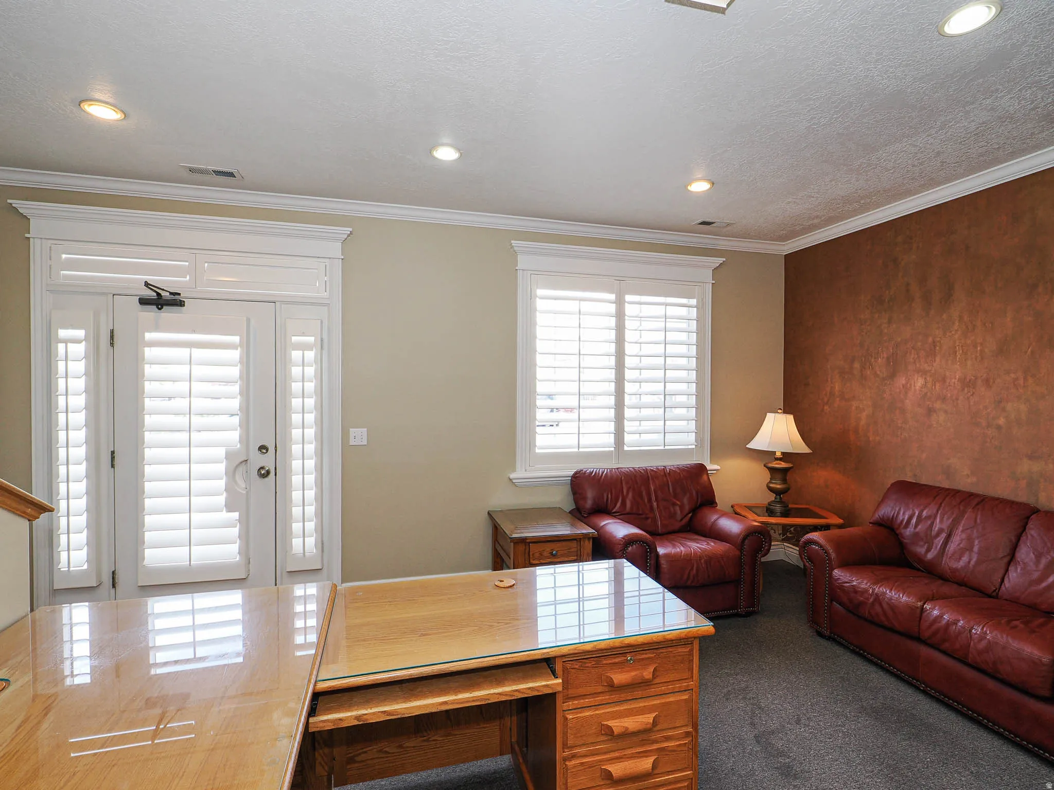 Living room featuring recessed lighting, crown molding, dark colored carpet, and a textured ceiling