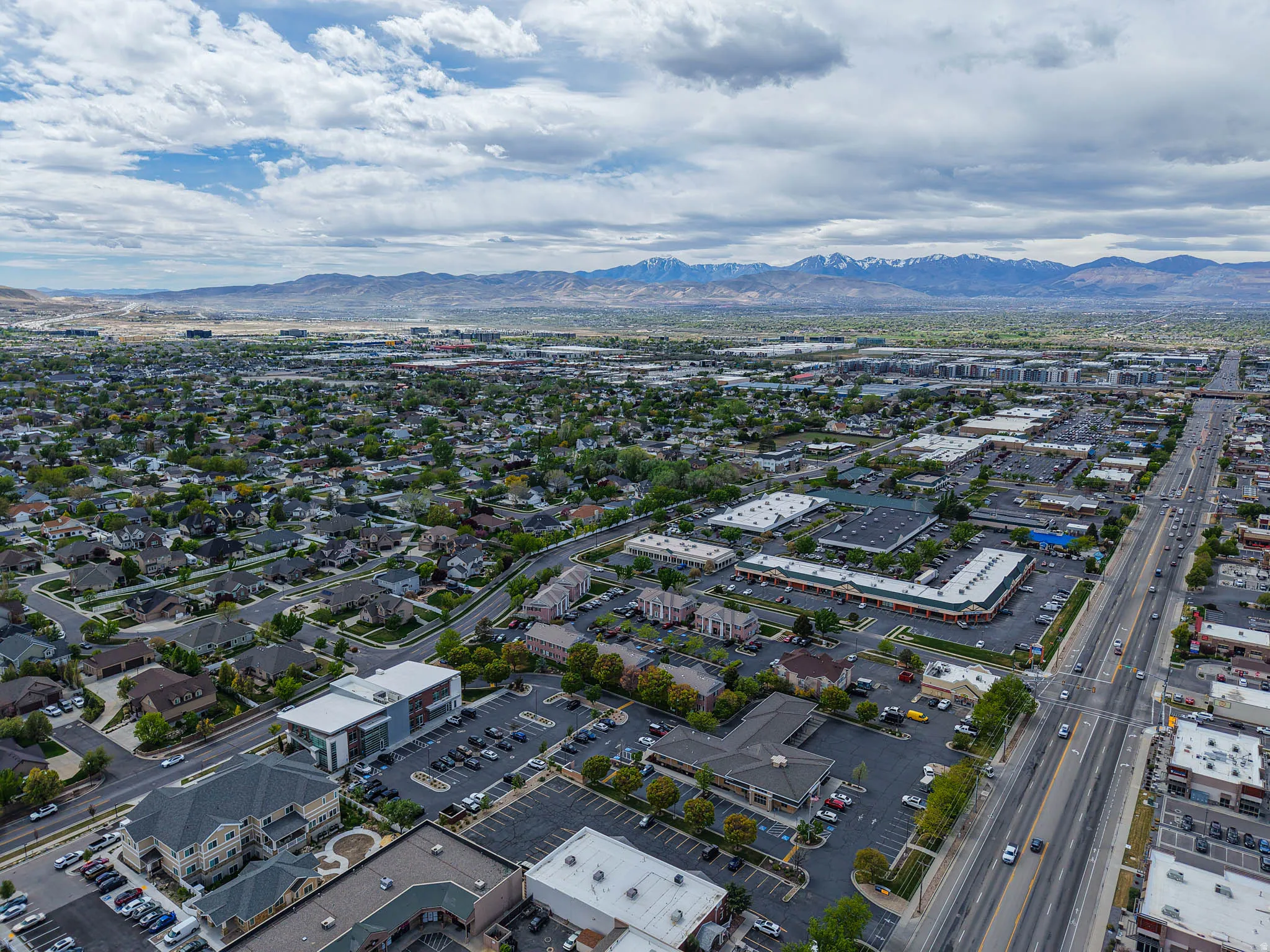 Aerial view of property and surrounding area with a mountain backdrop