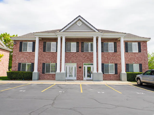 View of property with uncovered parking