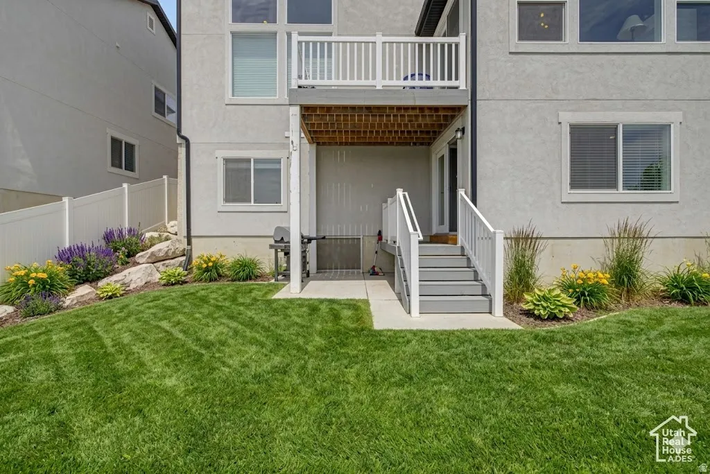 Ai enhanced backyard  green lawn with a white vinyl privacy fence