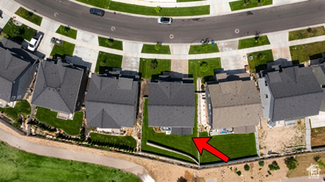 Ai enhanced Aerial perspective showcasing a residential neighborhood with properties bordering open green space