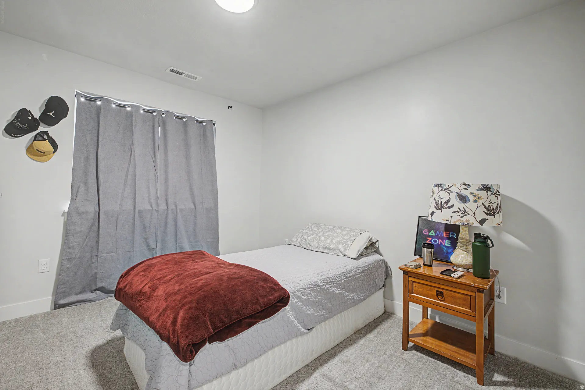 Carpeted room featuring a single window with curtain rods, recessed ceiling lighting, and light-toned walls