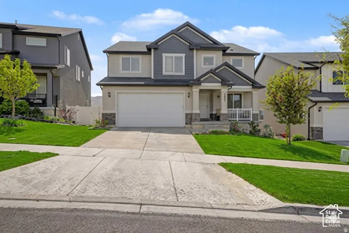 Ai enhanced front yard of this modern two-story residence featuring a two-car garage, covered entry porch with white railing, and a combination of siding and stone veneer exterior