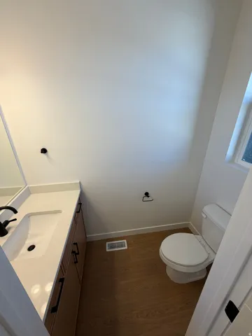 Vanity with an integrated sink, black faucet, and white countertop