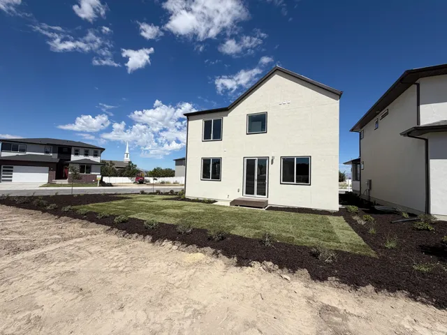 Rear exterior with light-colored stucco finish