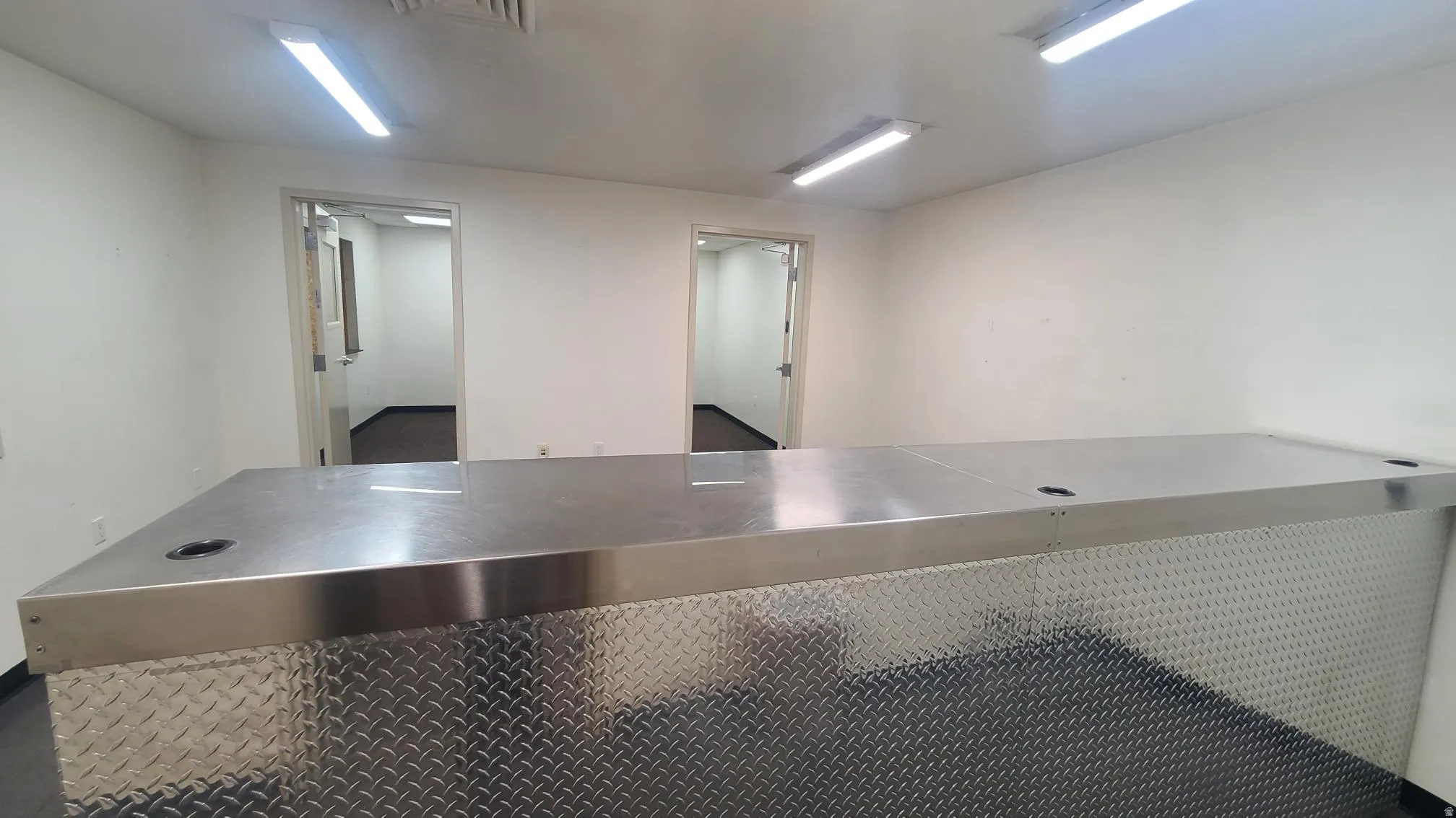 Spacious interior featuring a large diamond plate counter with an integrated metallic surface