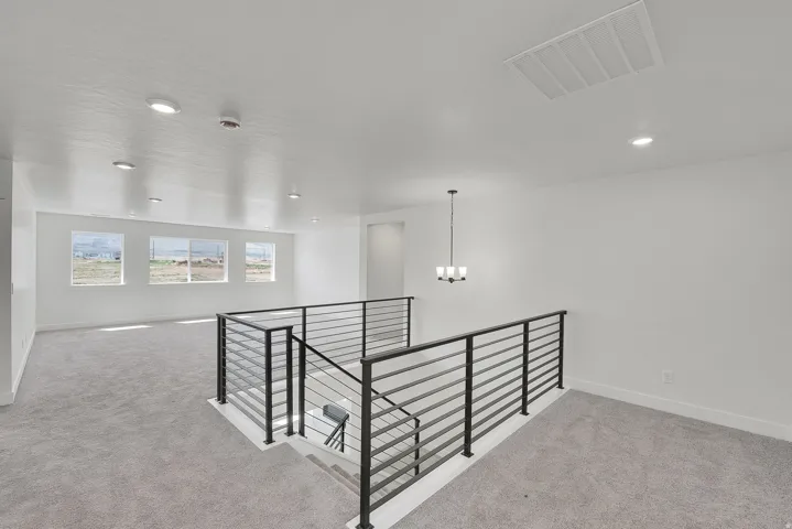 Open upper-level space featuring contemporary metal railings