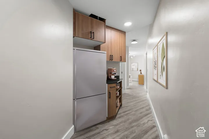 ADU * 2nd Kitchen * VIRTUALLY STAGED Hallway kitchenette with wood-finish cabinetry and a stainless steel refrigerator