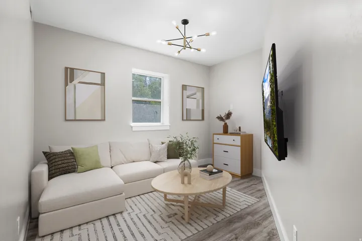 VIRTUALLY STAGED / ADU Living space featuring wood-finish flooring, a modern chandelier, and a window with white trim