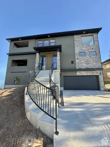 Contemporary exterior with stone veneer accents