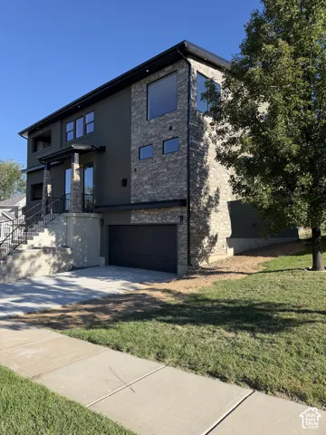 Modern exterior featuring stone veneer and stucco finishes