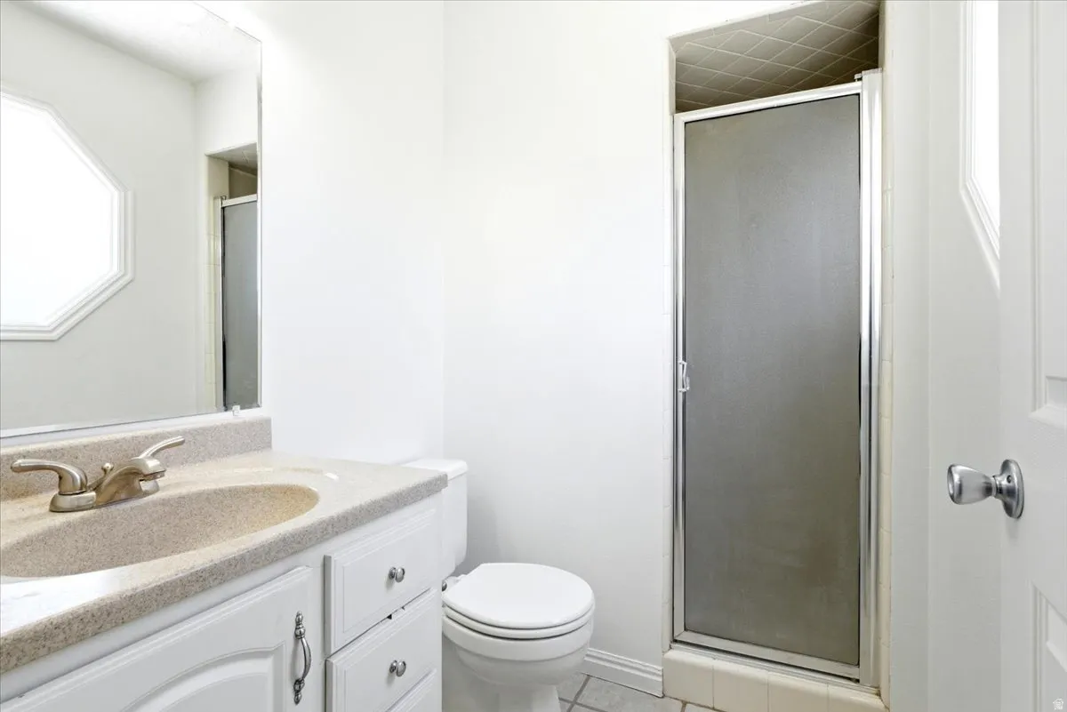Bathroom with a white vanity featuring a speckled countertop and integrated sink