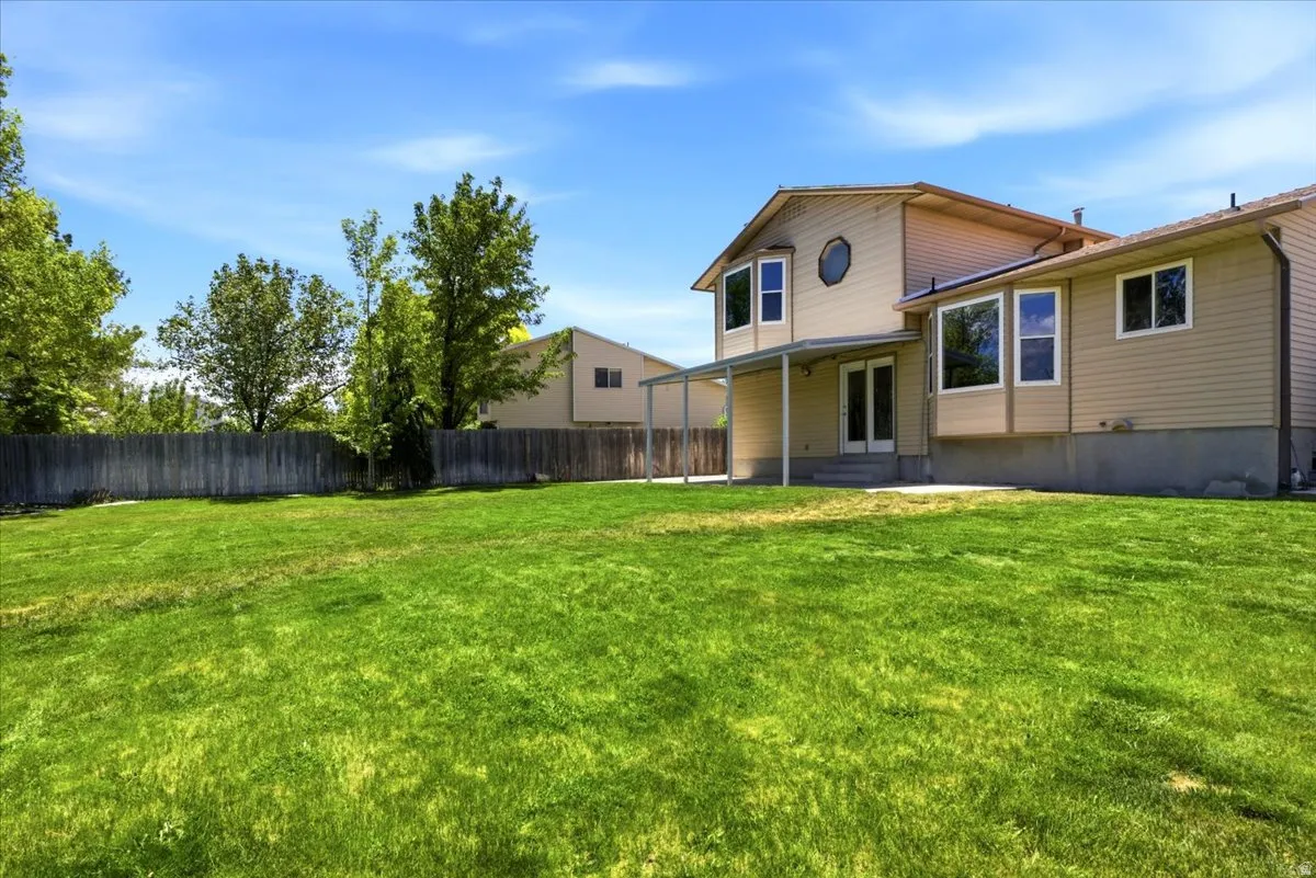 Expansive green lawn with mature perimeter trees