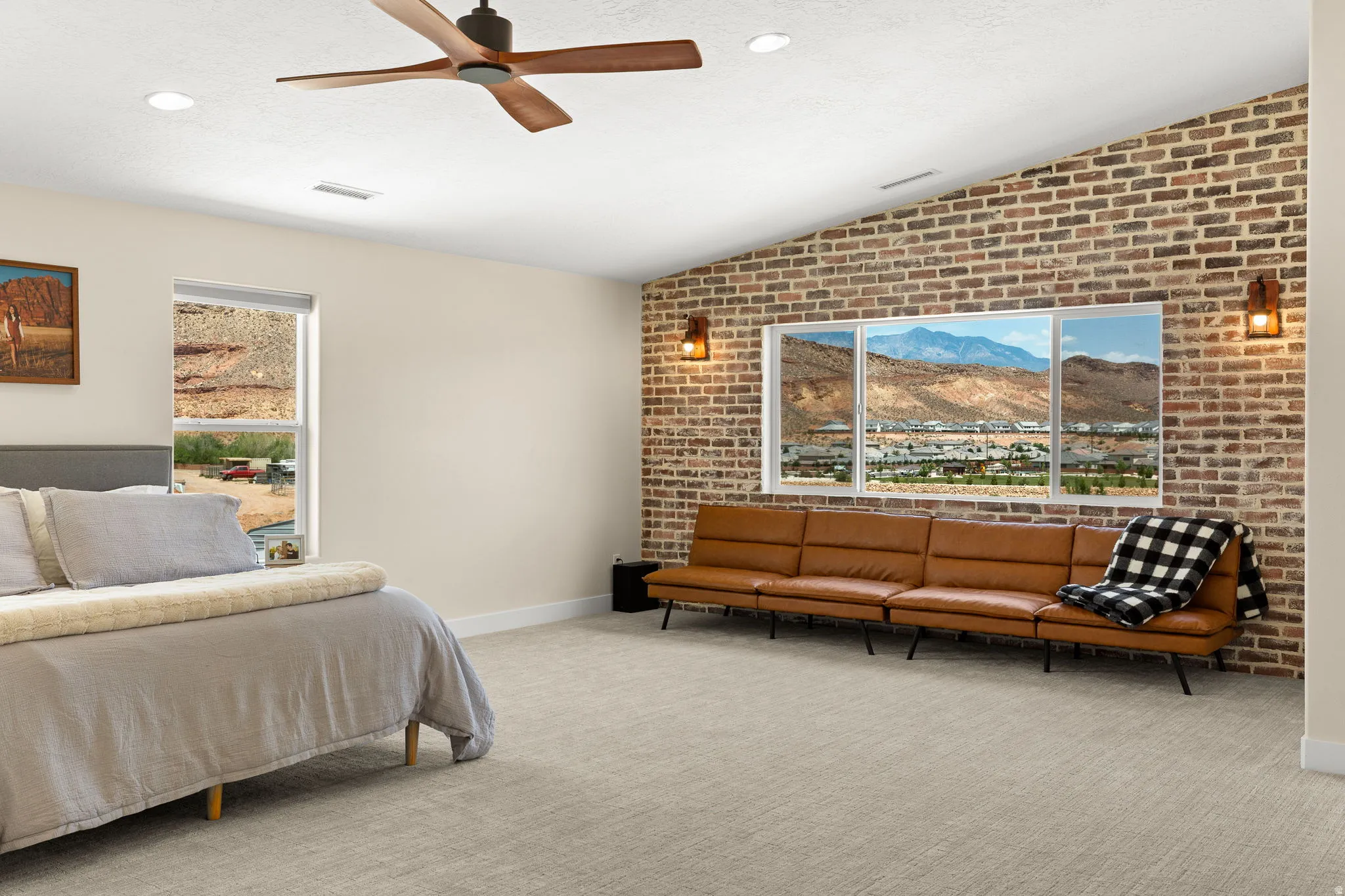 Vaulted ceiling with a wood-finish ceiling fan and recessed lighting