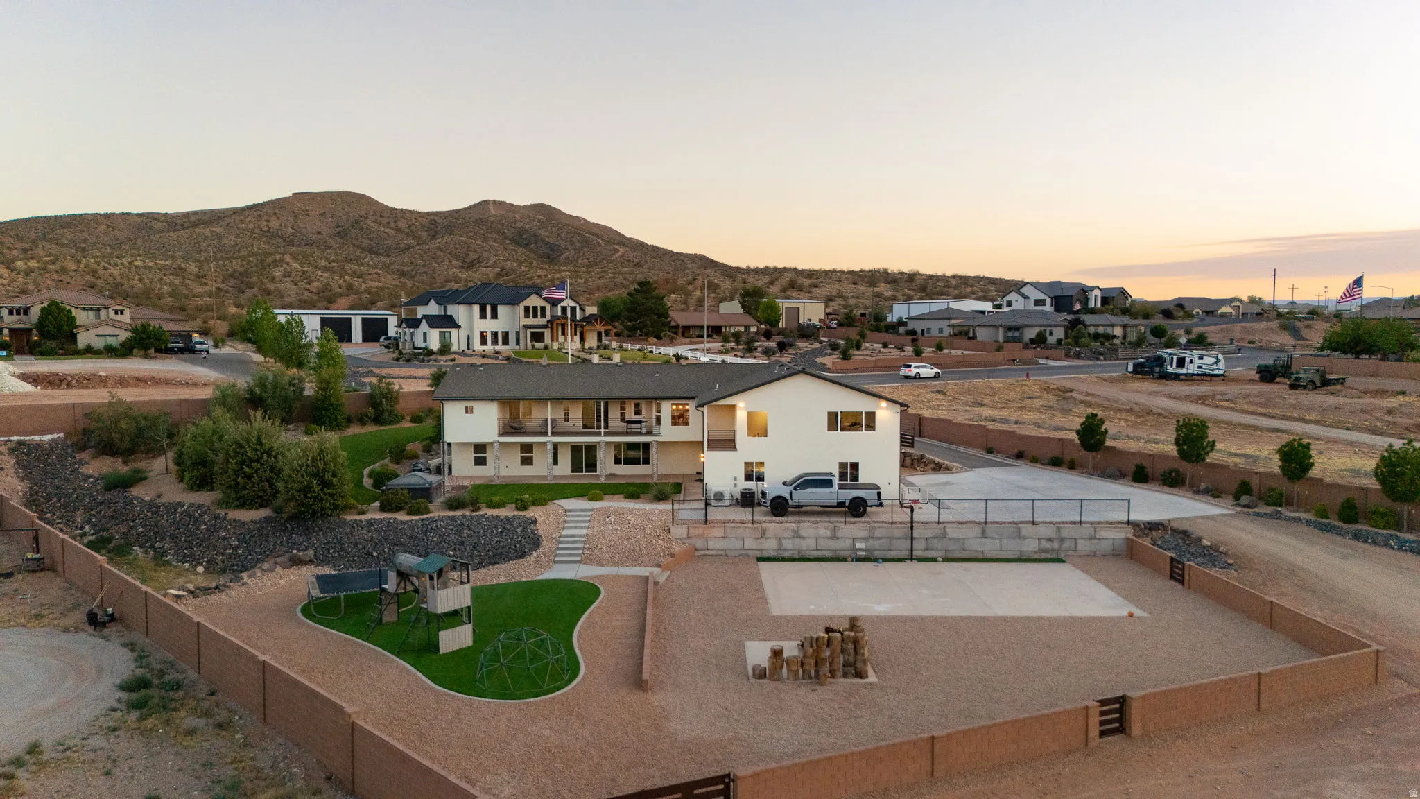 Expansive property featuring a two-story residence with multiple balconies and a large fenced yard