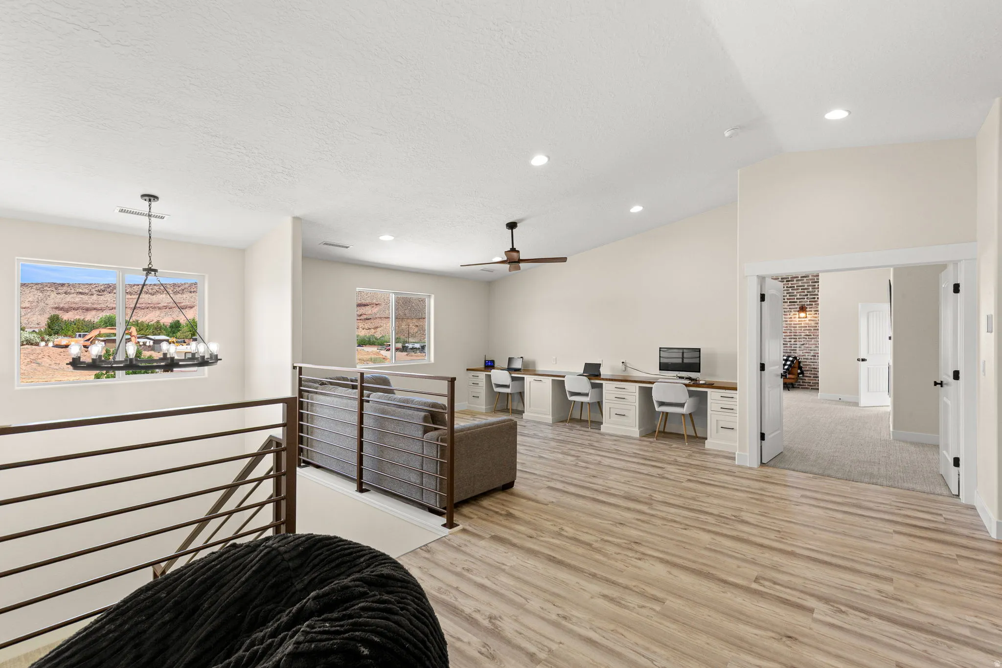 Spacious loft area featuring wood-finish flooring, vaulted ceilings, and recessed lighting
