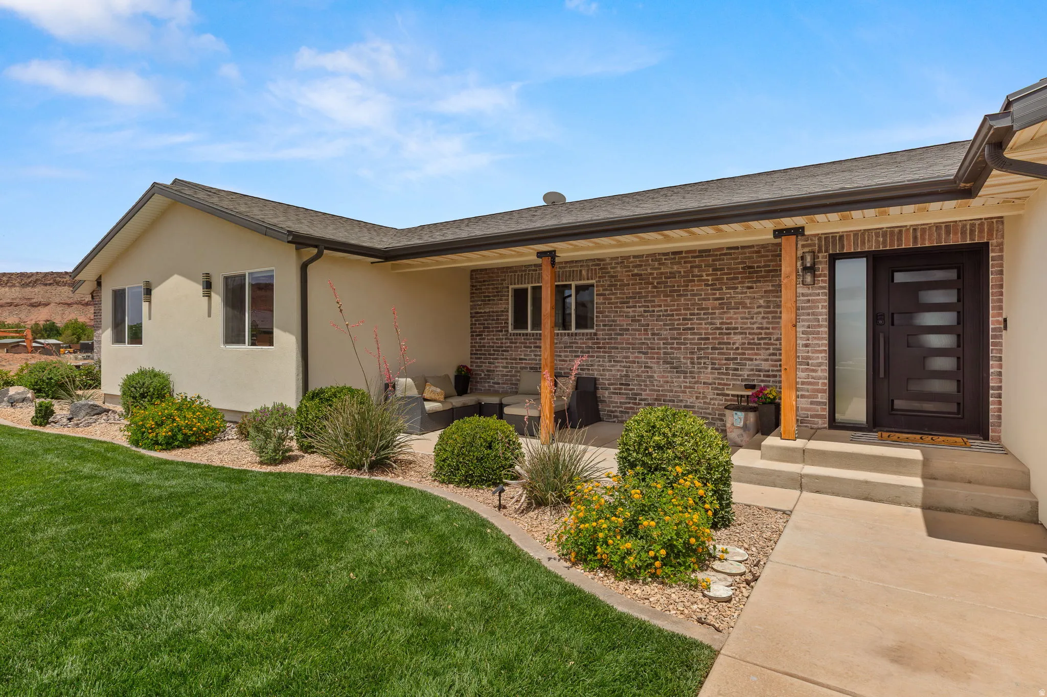Contemporary exterior with stucco and brick accents
