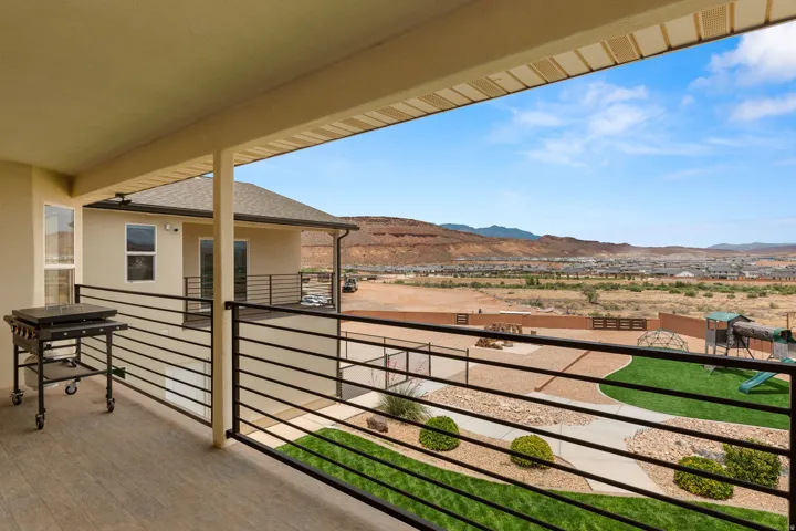 Covered outdoor living space featuring wood-finish flooring and black horizontal railings
