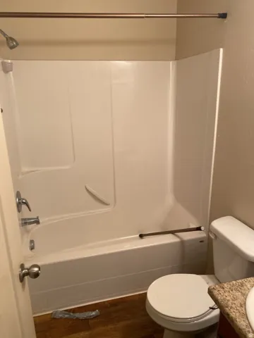 750-White fiberglass tub and shower combination with chrome fixtures