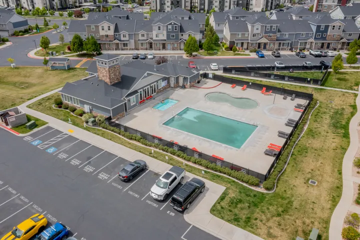 Community amenity building featuring a stone-clad turret and a dark shingle roof