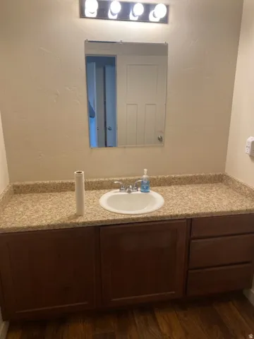 750-Vanity featuring a white basin sink, polished chrome faucet, and speckled countertop