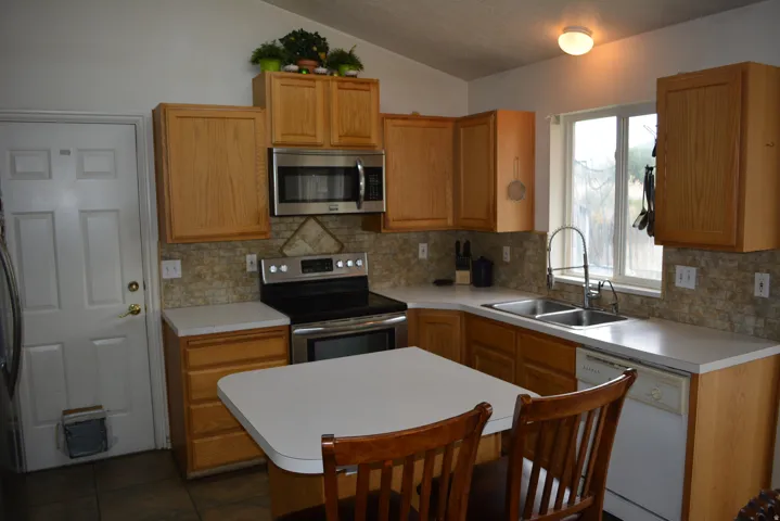 Kitchen with wood-finish cabinetry and a complementary tiled backsplash
