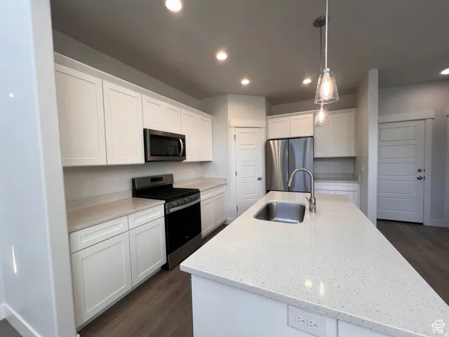 Contemporary kitchen featuring an expansive island with an undermount sink and a gooseneck faucet